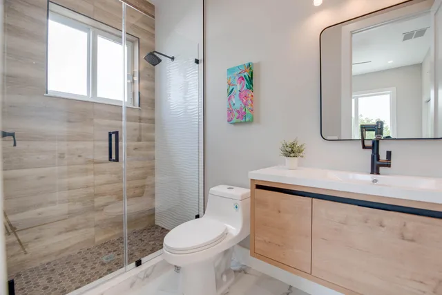 a bathroom with a toilet sink and shower
