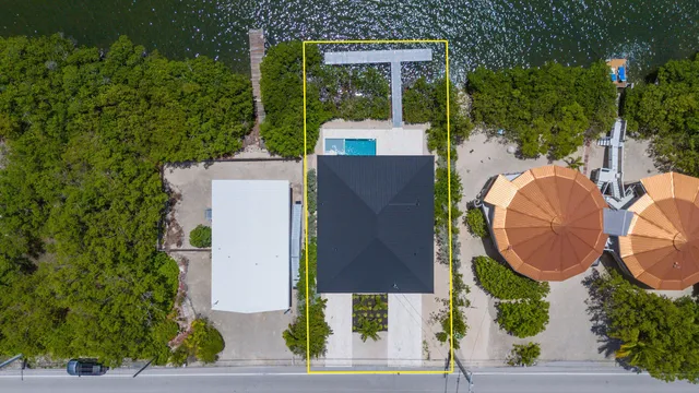 an aerial view of a house with garden space and balcony