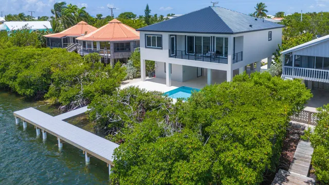 a front view of a house with yard and outdoor seating