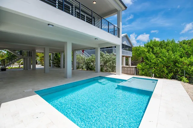 a view of a house with backyard porch and sitting area