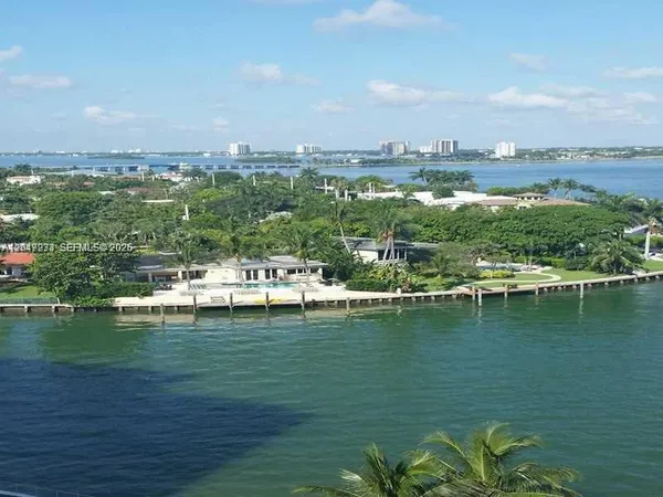 a view of a lake with houses in the back