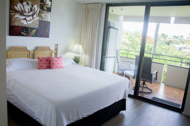 a room with a bed and a cabinets