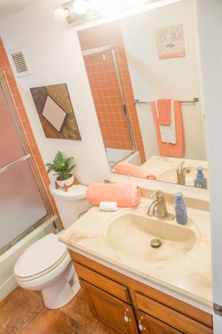 a bedroom with a bed and a lamp