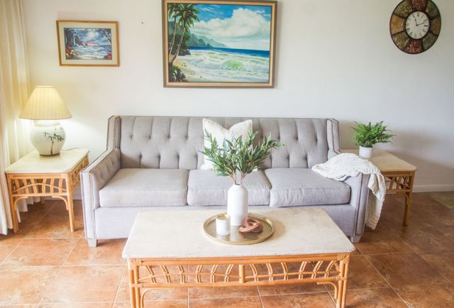 a living room with furniture potted plant and a flat screen tv