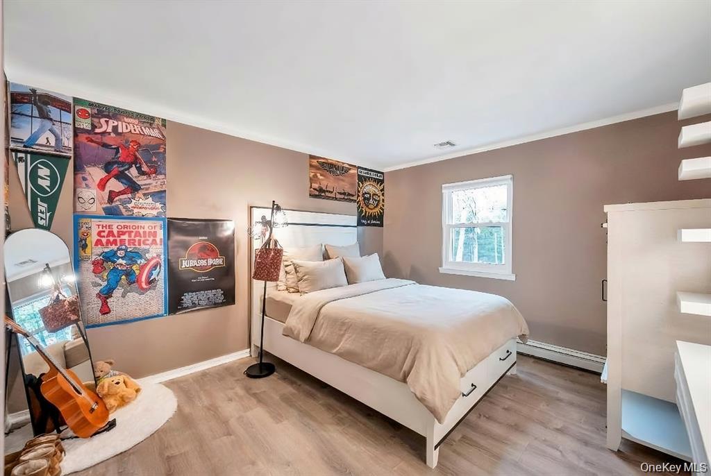 10 Ramblewood Road Ridge, NY 11961 - Photo 36 of 39 a bedroom with a bed and a window