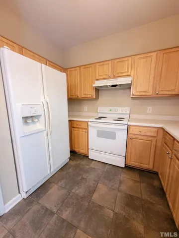 a view of a kitchen with a sink stove and refrigerator