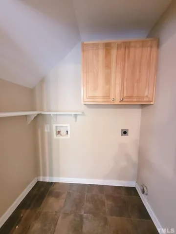 a view of a livingroom with wooden floor and a bathroom