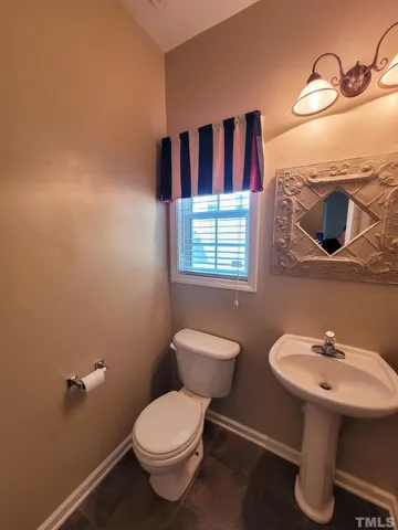 a view of a hallway with wooden floor and a cabinet