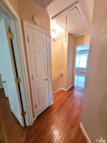 a view of a room with wooden floor and a ceiling fan