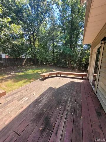 a swimming pool with yard and outdoor seating