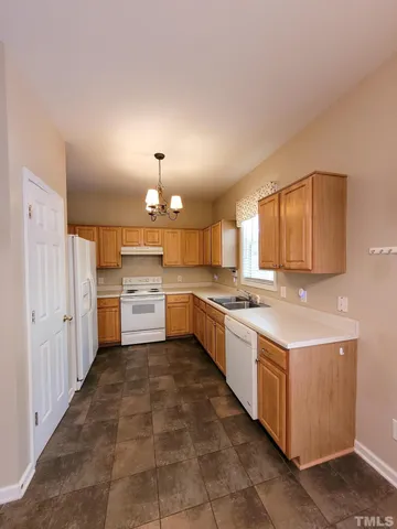 a kitchen with a sink cabinets and window
