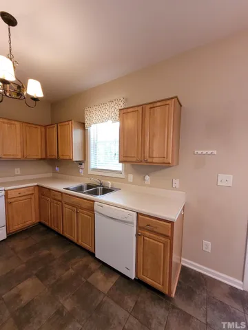 a kitchen with a stove sink and a refrigerator