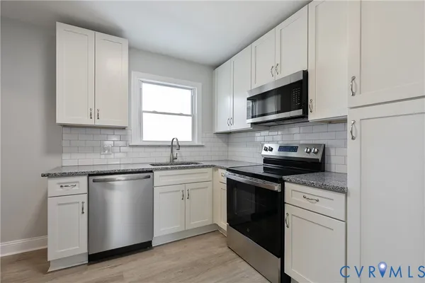 a kitchen with a stove and a microwave