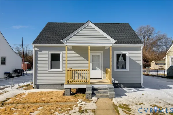 a view of a house with snow on the road