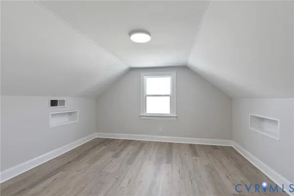 a view of a room with wooden floor