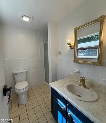 a bathroom with a sink toilet and mirror