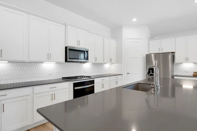 a kitchen with a refrigerator stove and microwave