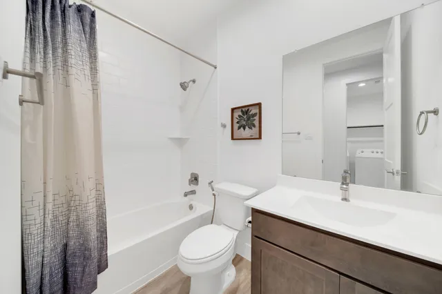 a bathroom with a sink toilet and shower