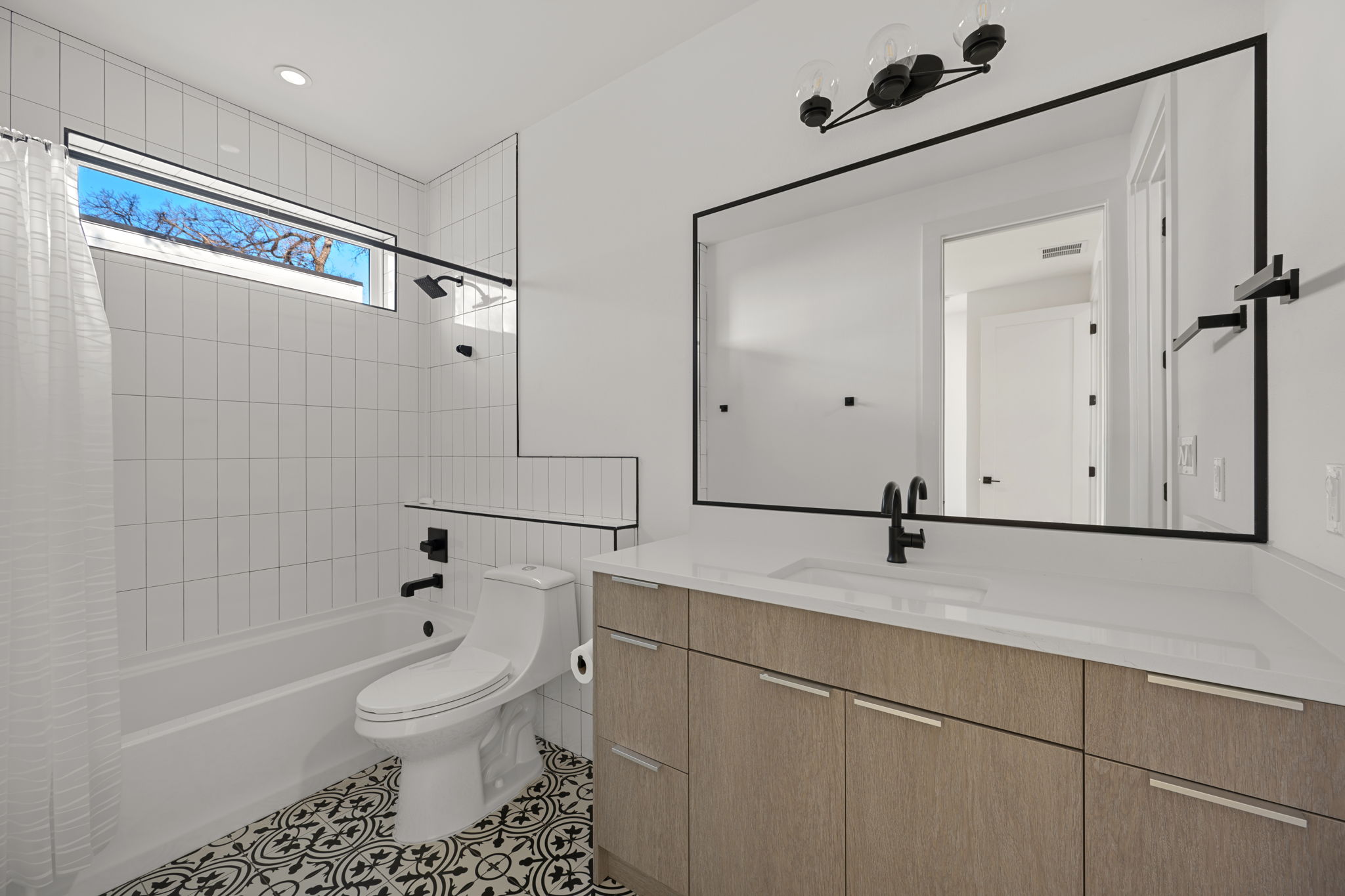 910 Nalide Street, Unit B Austin, TX 78745 - Photo 30 of 38 a bathroom with a sink toilet and shower