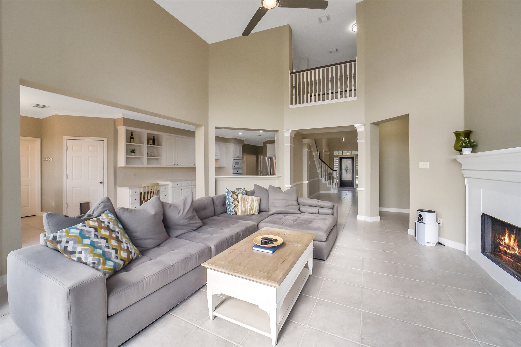 24403 Falcon Point Drive Katy, TX 77494 - Photo 7 of 32 A closer look at the expansive living room, highlighting the open-concept layout that seamlessly connects to the kitchen and breakfast area.