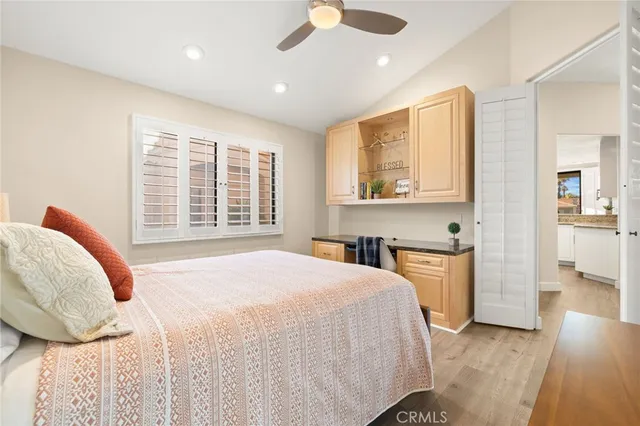 a bedroom with a bed and a large window