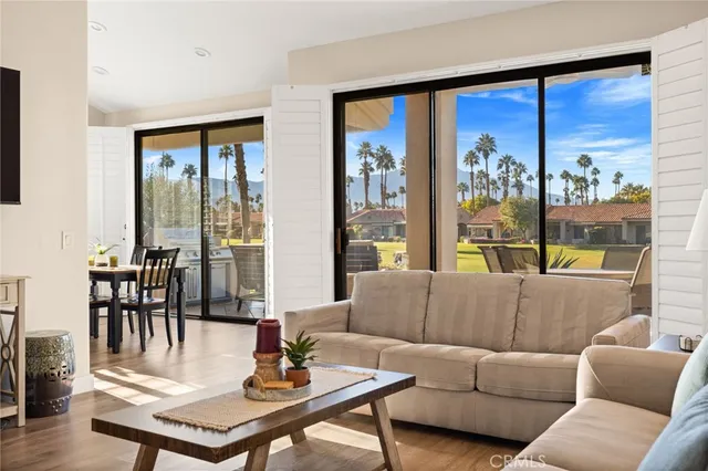 a living room with furniture and a floor to ceiling window