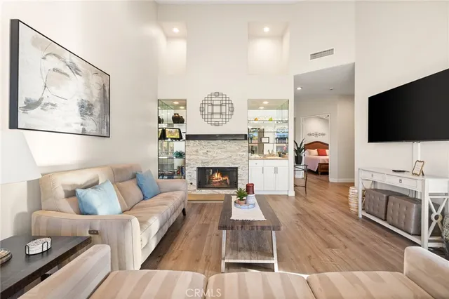 a living room with furniture a flat screen tv and a fireplace