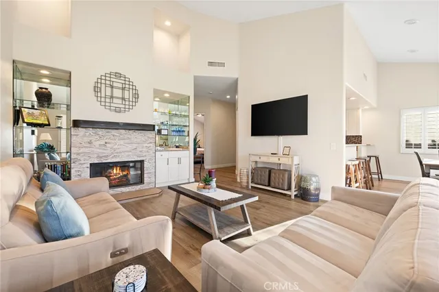 a living room with furniture a fireplace and a flat screen tv