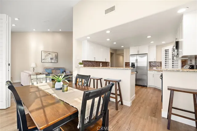 a view of kitchen with kitchen island dining table and chairs