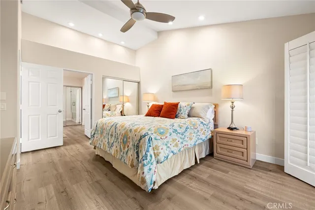 a bedroom with a bed and wooden floor