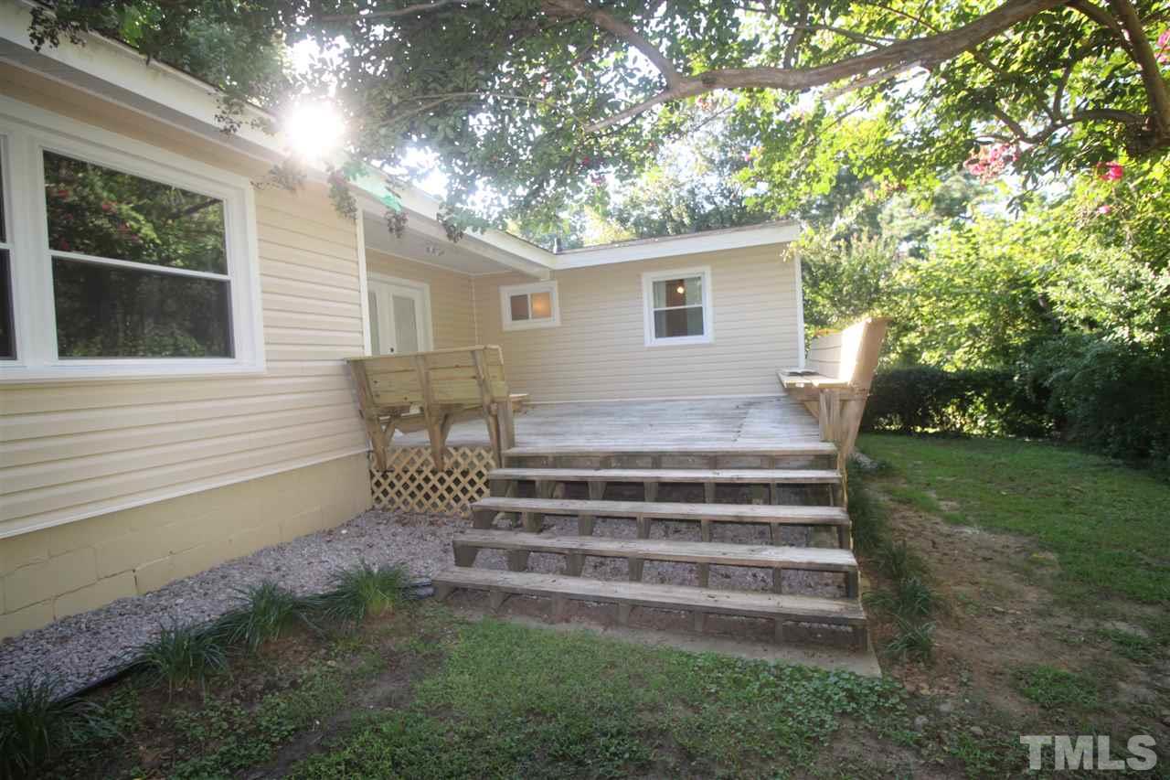 1409 Kelly Road Garner, NC 27529 - Photo 15 of 20 a view of a house with backyard and a sitting area