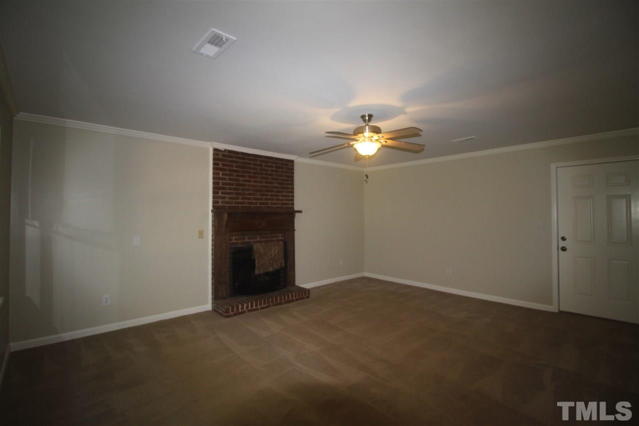 1409 Kelly Road Garner, NC 27529 - Photo 5 of 20 a view of an empty room with a chandelier fan
