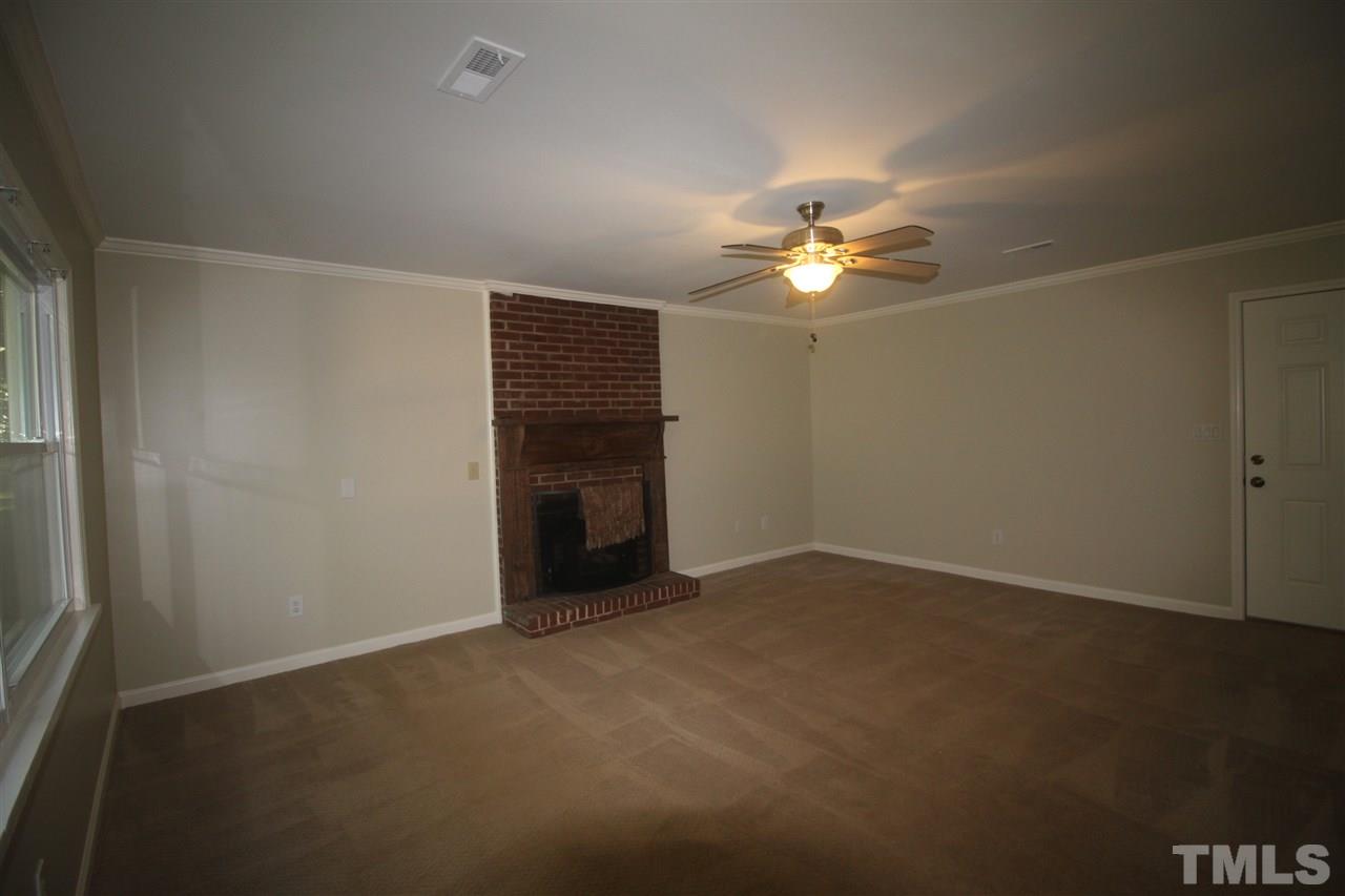 1409 Kelly Road Garner, NC 27529 - Photo 6 of 20 an empty room with a ceiling fan and a window