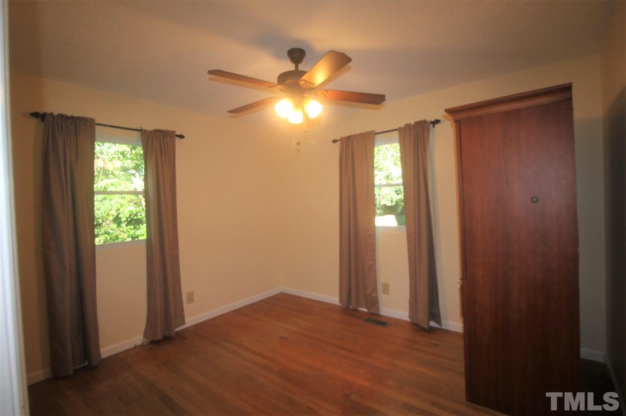 1409 Kelly Road Garner, NC 27529 - Photo 8 of 20 a view of an empty room with window and wooden floor
