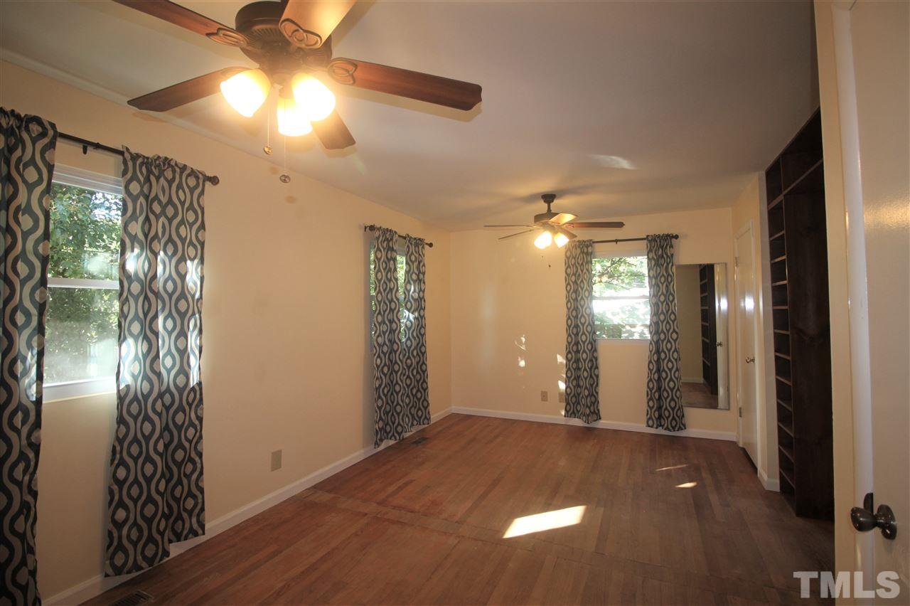 1409 Kelly Road Garner, NC 27529 - Photo 9 of 20 a view of empty room with window and ceiling fan