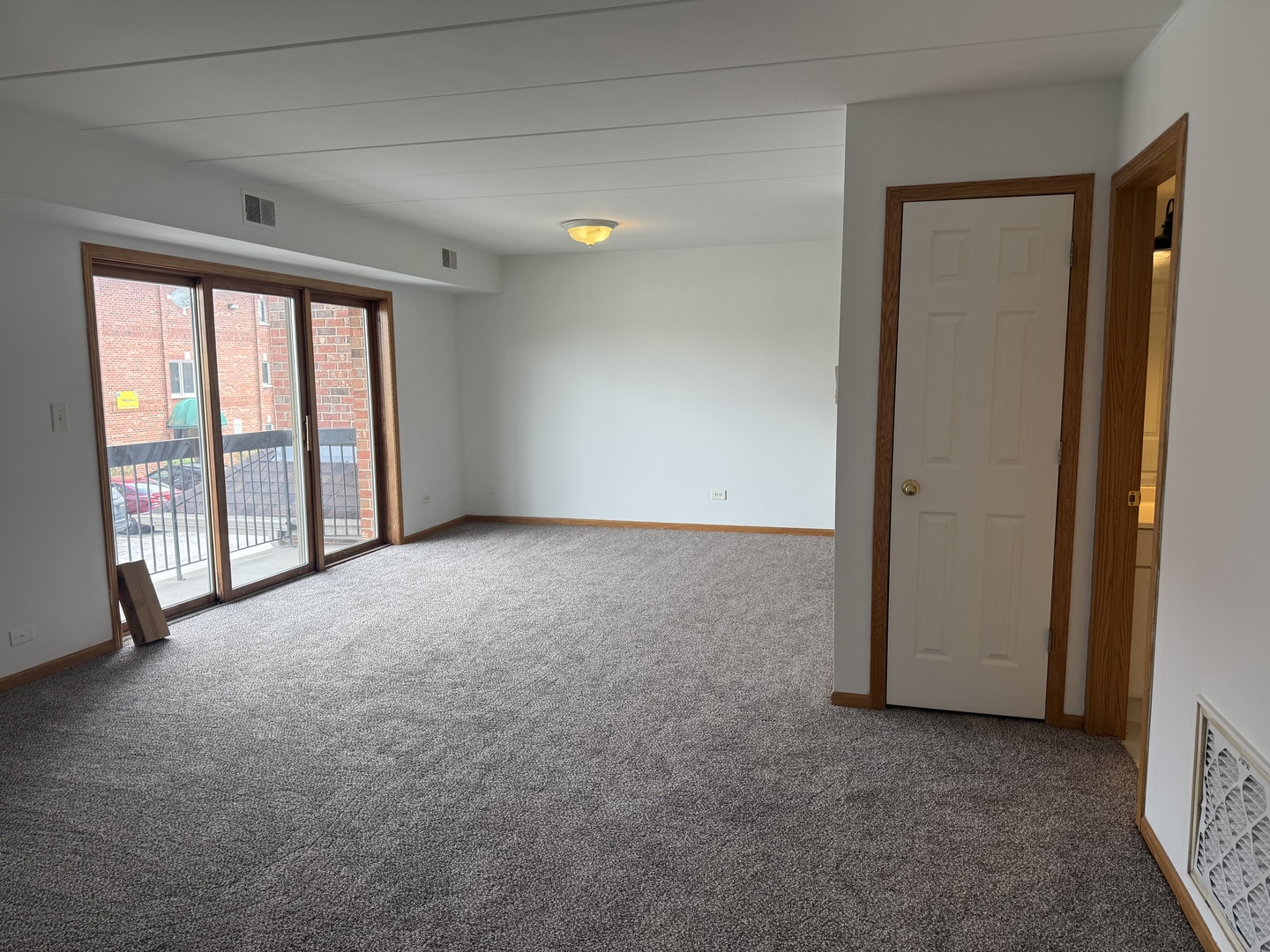 5627 107th Street, Unit 2E Chicago Ridge, IL 60415 - Photo 4 of 9 an empty room with windows