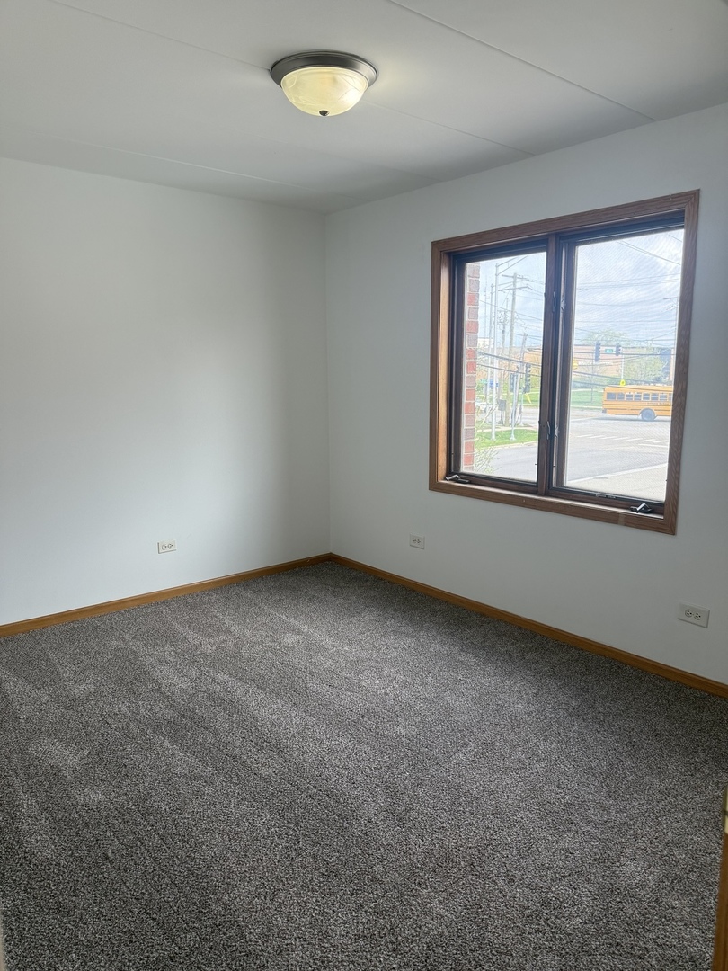 5627 107th Street, Unit 2E Chicago Ridge, IL 60415 - Photo 6 of 9 an empty room with a window