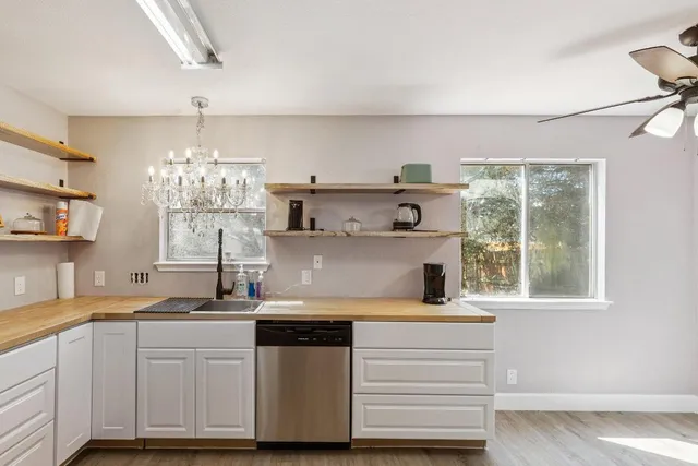 a kitchen with cabinets window and stainless steel appliances