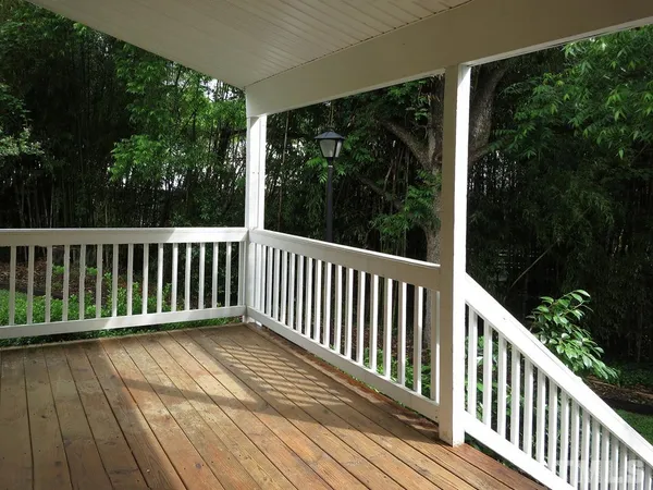 a view of balcony with wooden floor