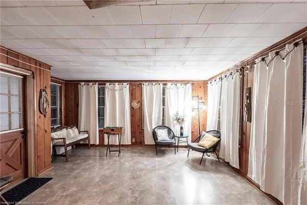 a living room with furniture a rug and a window