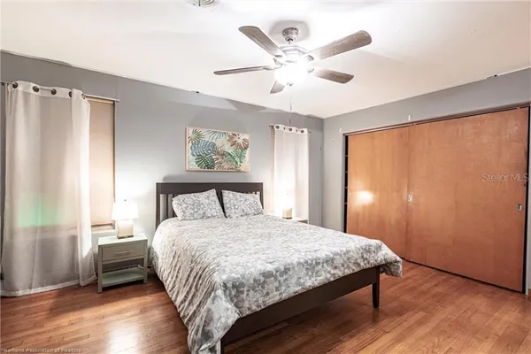 a bedroom with a large bed and a large window