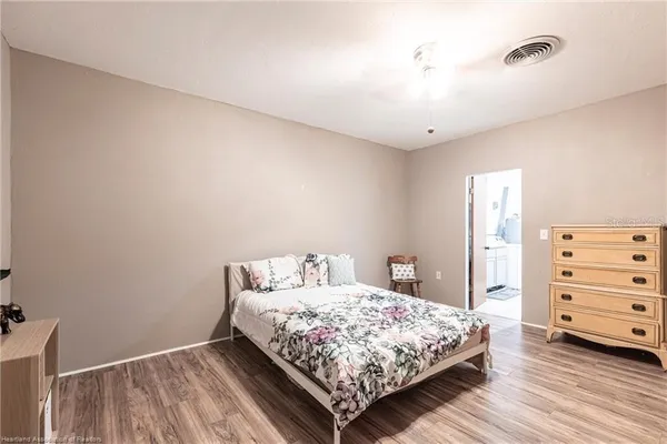 a bedroom with a bed and dresser