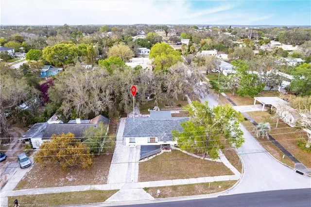 an aerial view of a house with a yard