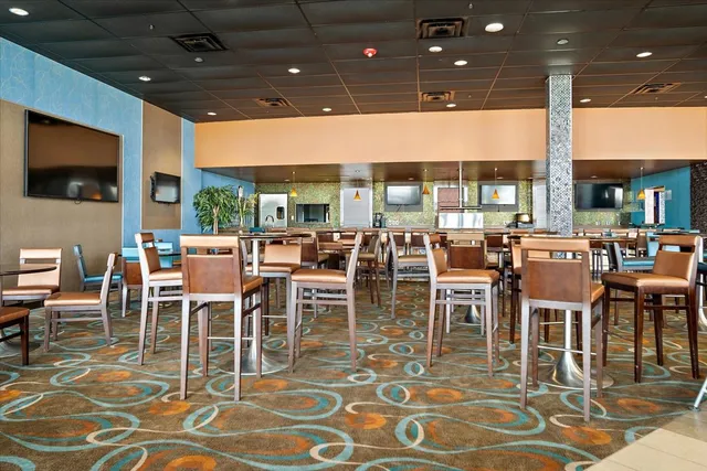 a dining room with lots of tables and chairs