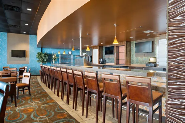 a kitchen with a sink and chairs