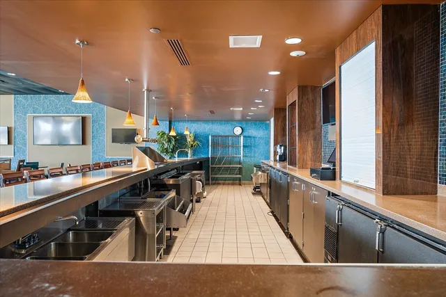 a kitchen with lots of counter top space and wooden floor