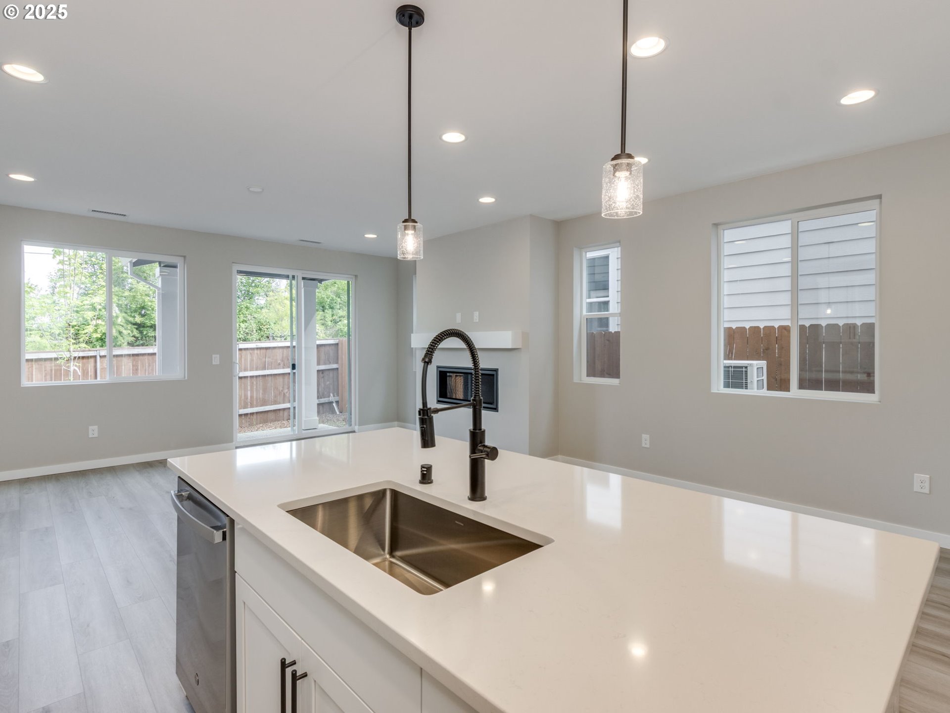 838 Northwest 178th Street Ridgefield, WA 98642 - Photo 7 of 33 a kitchen with a sink a large window and stainless steel appliances