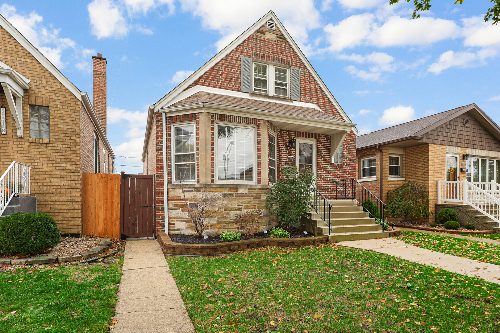 5416 South Rutherford Avenue Chicago, IL 60638 - Photo 3 of 25 a front view of a house with a yard