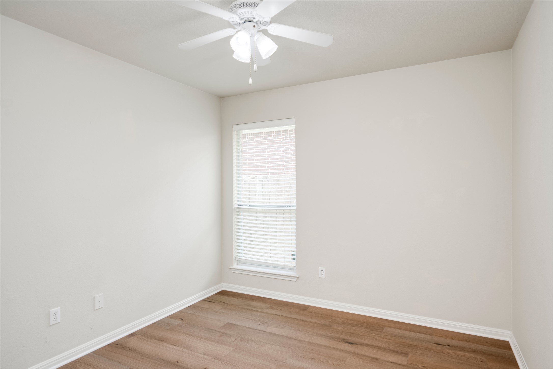 1813 Nelson Ranch Loop Cedar Park, TX 78613 - Photo 25 of 39 A well-lit bedroom features durable hardwood flooring and a functional ceiling fan for comfort.