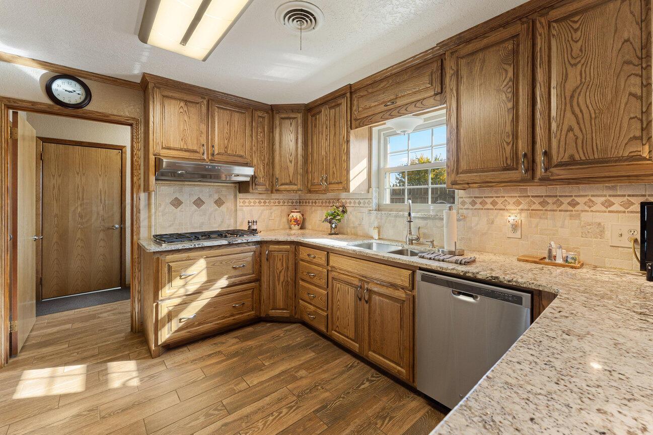 148 Buffalo Trail Fritch, TX 79036 - Photo 12 of 81 a kitchen with granite countertop a sink cabinets and stainless steel appliances